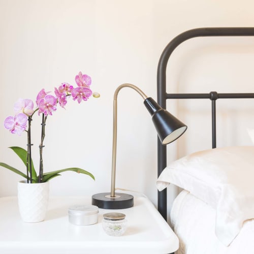 Bedroom night stand and flowers at Village at Santa Teresa in Gilroy, California