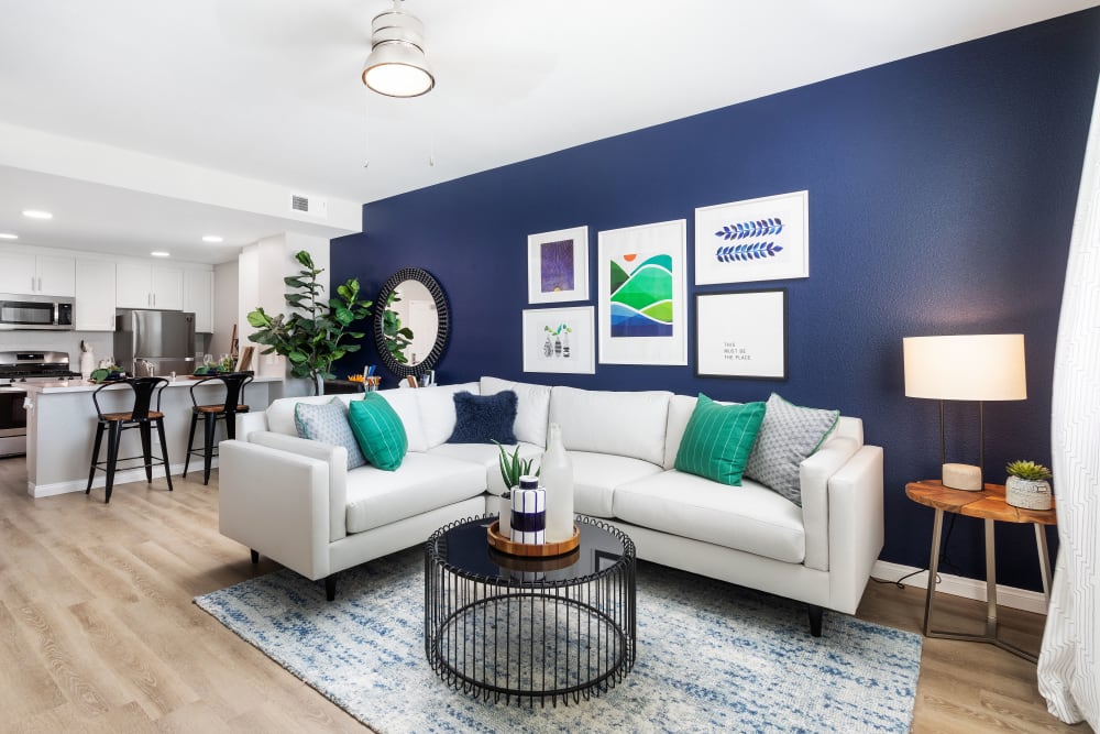 couch in a living room against a blue back wall at Azure Apartment Homes in Santa Maria, California