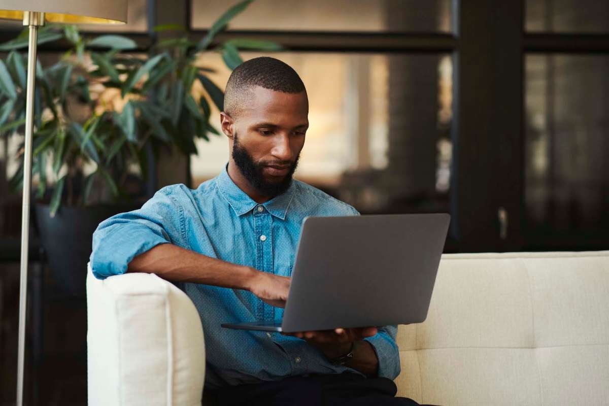 A man fills out a contact form on his laptop Hangar at Thunderbird in Glendale, Arizona