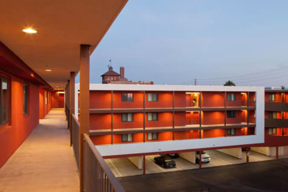 Exterior hallway and view of red building at Mission Apartments in San Diego, California