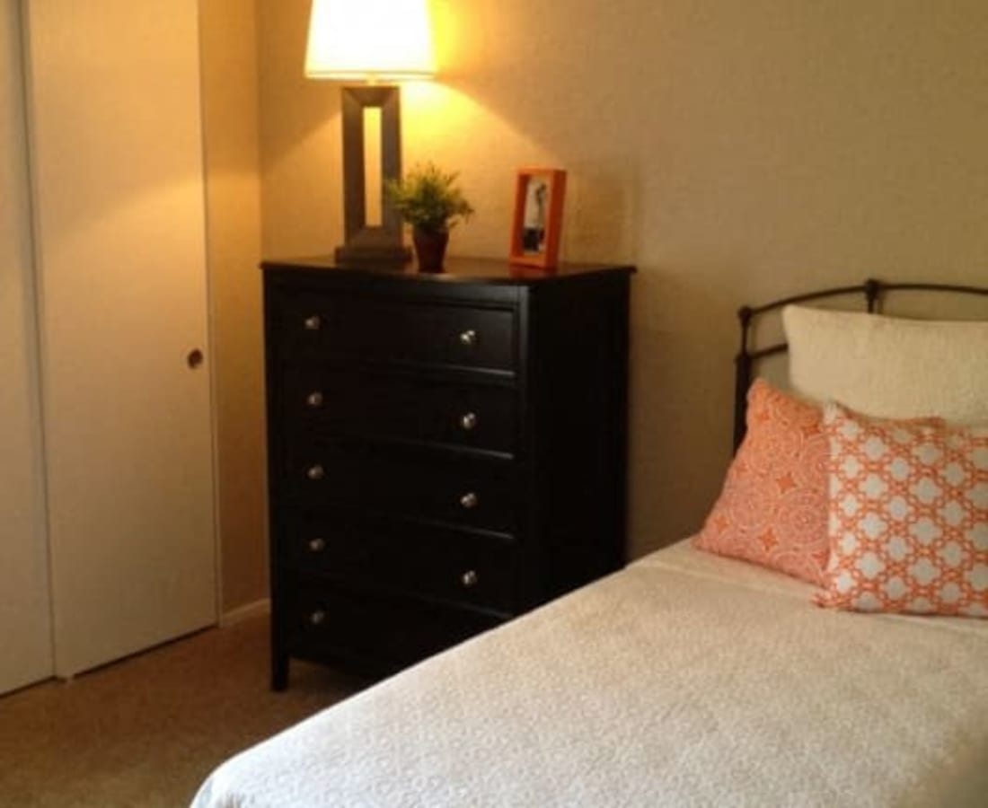 Bedroom with dresser at  The Grove at Davis in Davis, California