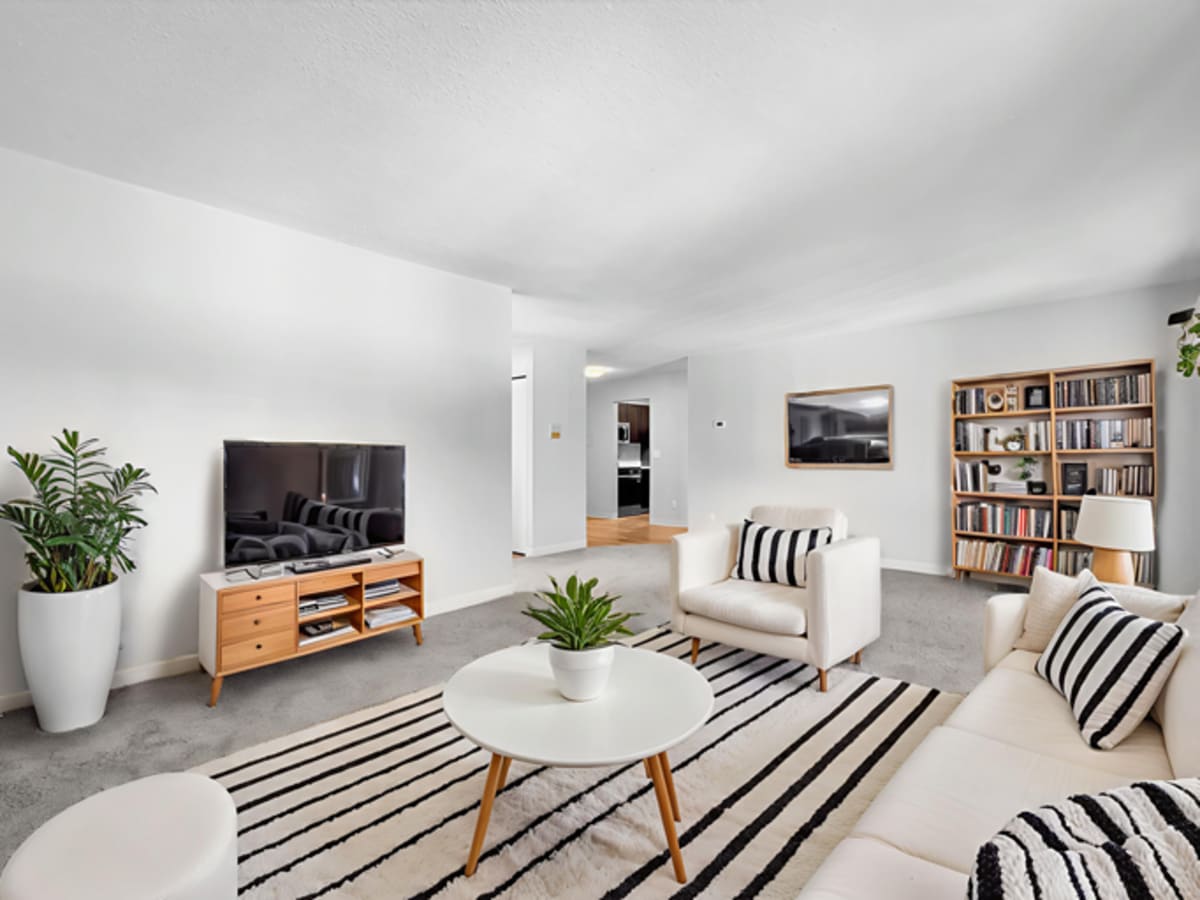 Unfurnished living room with air conditioner at Equinox Apartments in Saint Anthony, Minnesota