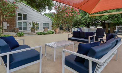 Outdoor couches by the pool at Villas de Santa Fe in San Antonio, Texas