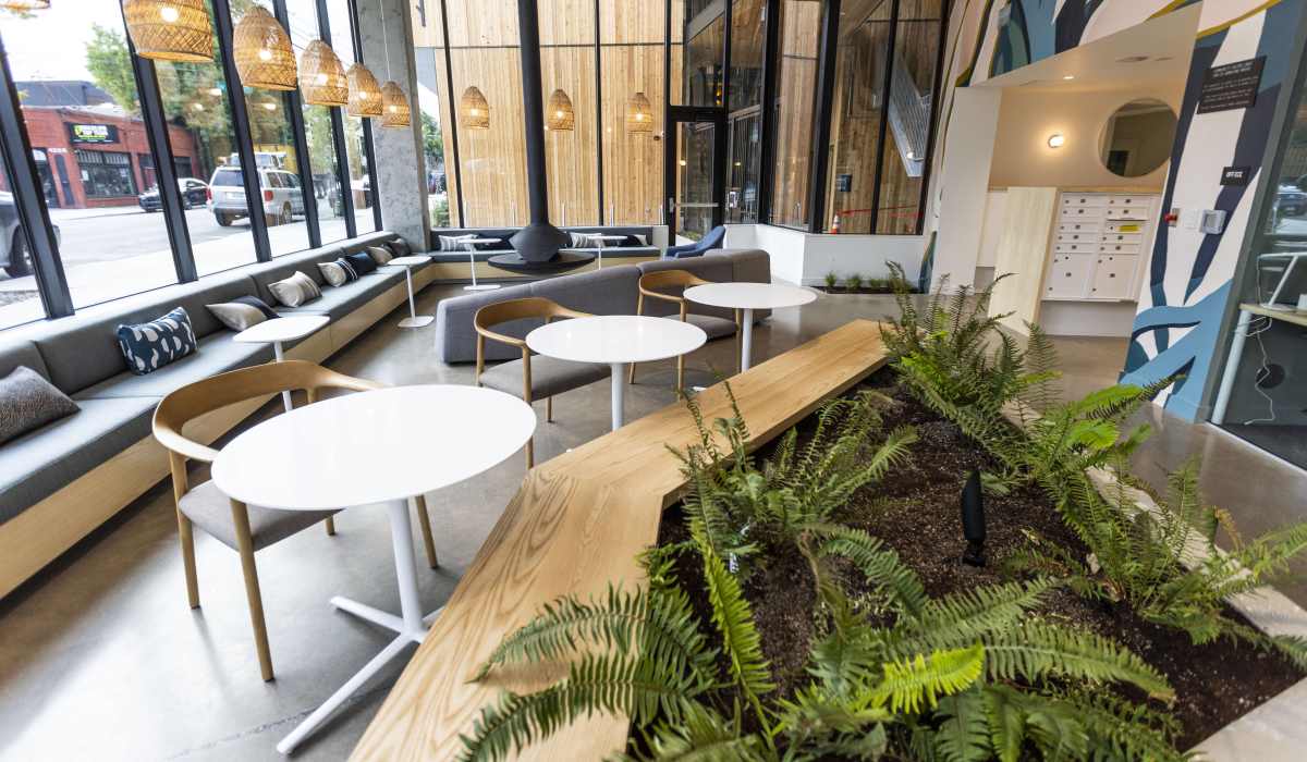 Indoor lounge area with plants and contemporary furniture at Brookland Apartments in Portland, Oregon