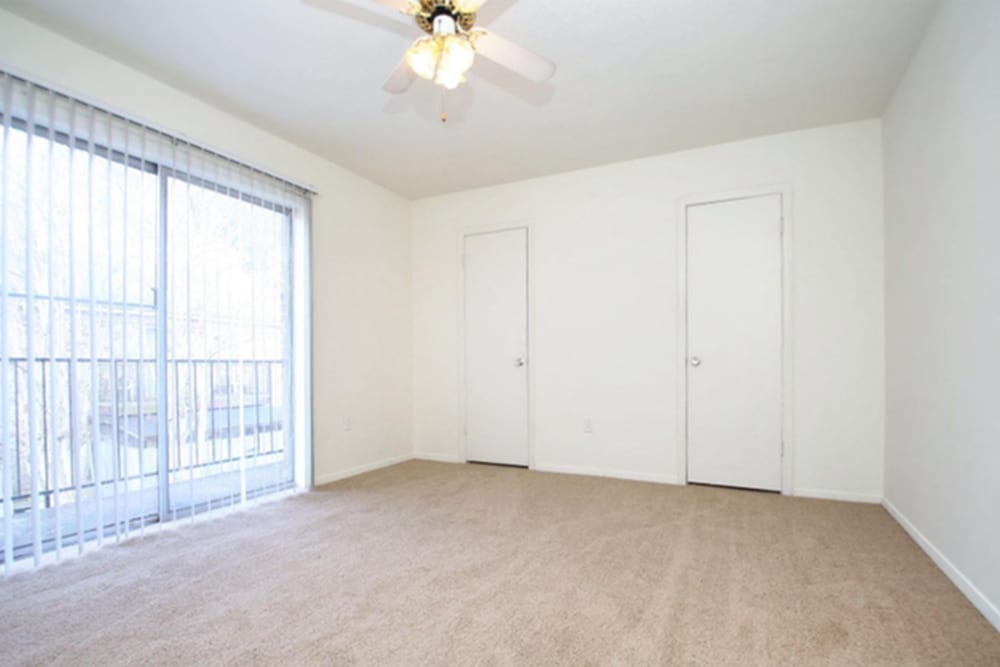 Spacious bedroom with large windows at Towne Oaks in Baton Rouge, Louisiana