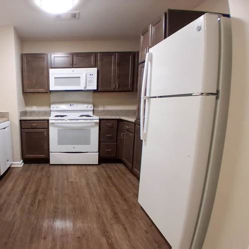Kitchen with rage and refrigerator at Adair Court in Atlanta, Georgia