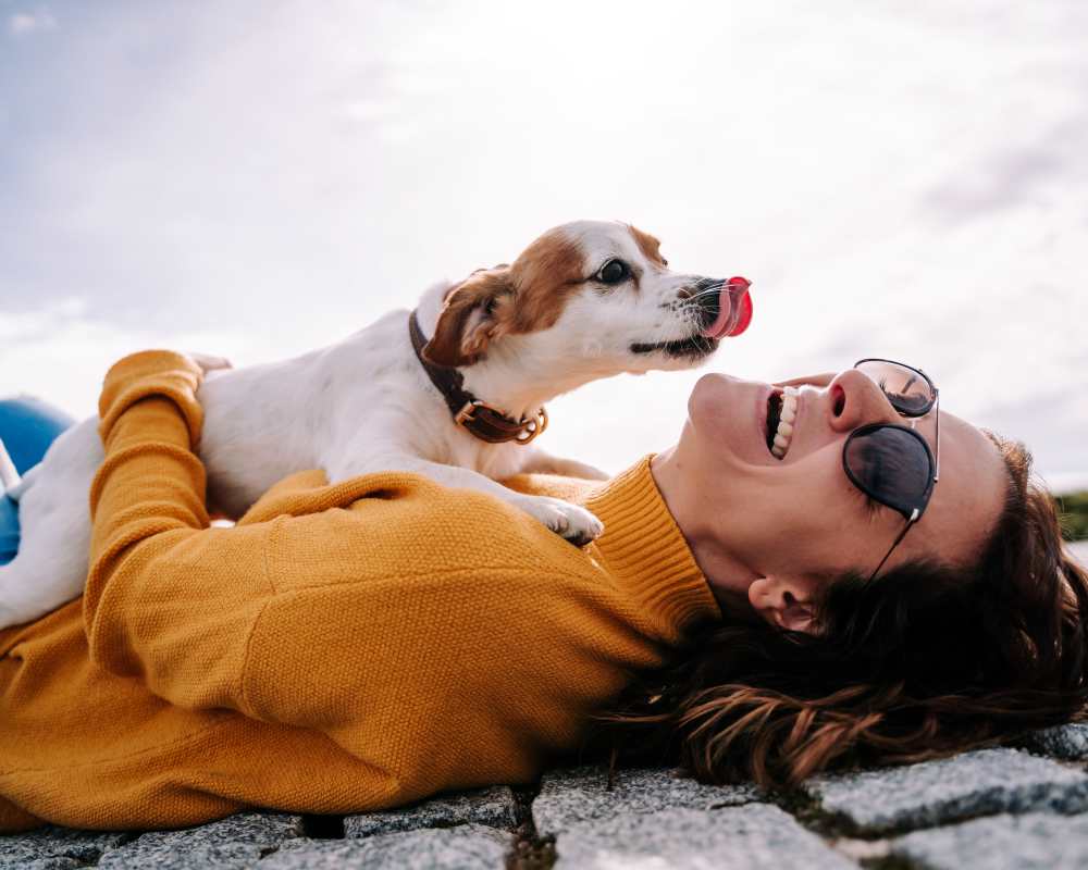 Resident and her dog posing for a photo outside at The Lock at Flatirons in Broomfield, Colorado