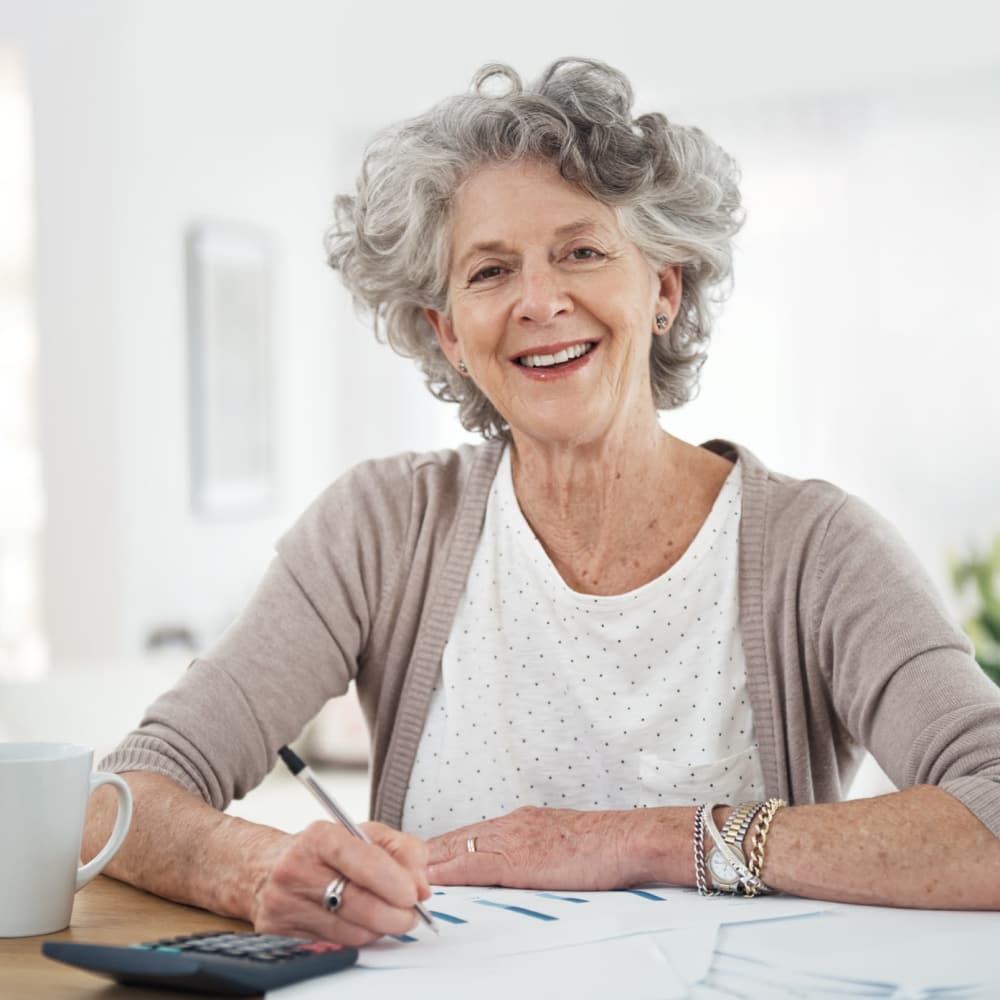 Senior writing and smiling at Singh Development Company