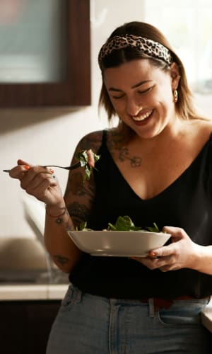 Resident having lunch in the kitchen of her home at Bent Creek Apartments in Lewisville, Texas