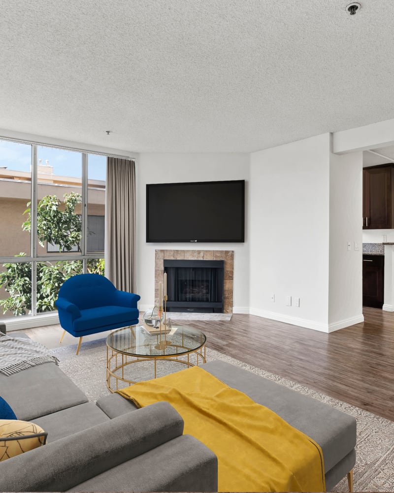 Living room with floor to ceiling windows at The Jessica Apartments, Los Angeles, California