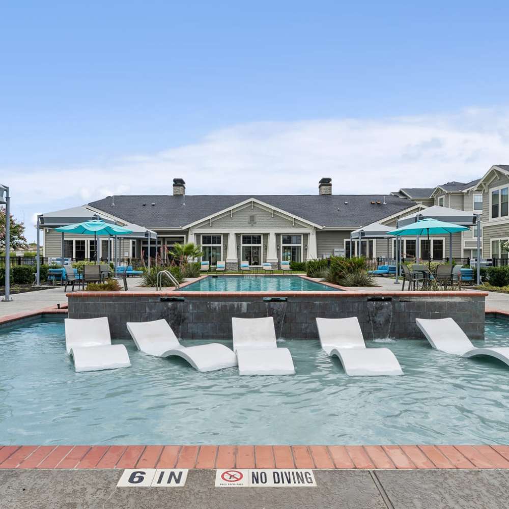 Poolside with seating at Aria Victoria Apartments in Victoria, Texas
