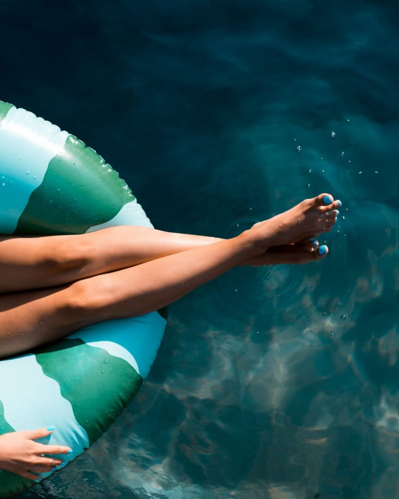 A resident on a floatie in the pool at Bay on 6th, Santa Monica, California