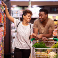 Couple shopping together at grocery store near 81 West Apartments in Fort Myers, Florida
