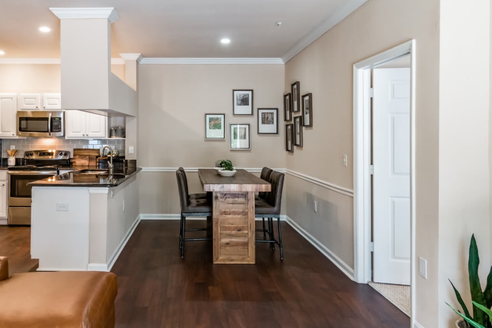 Spacious and bright living area with wood flooring at Marquis at Carmel Commons in Charlotte, North Carolina