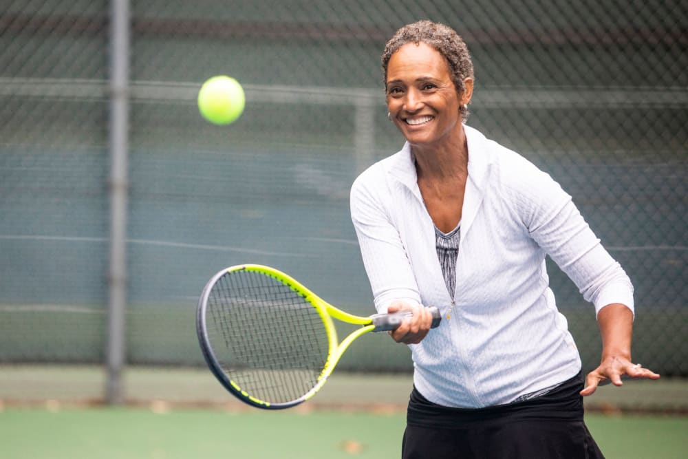 Resident playing tennis at Ponté Palmero in Cameron Park, California