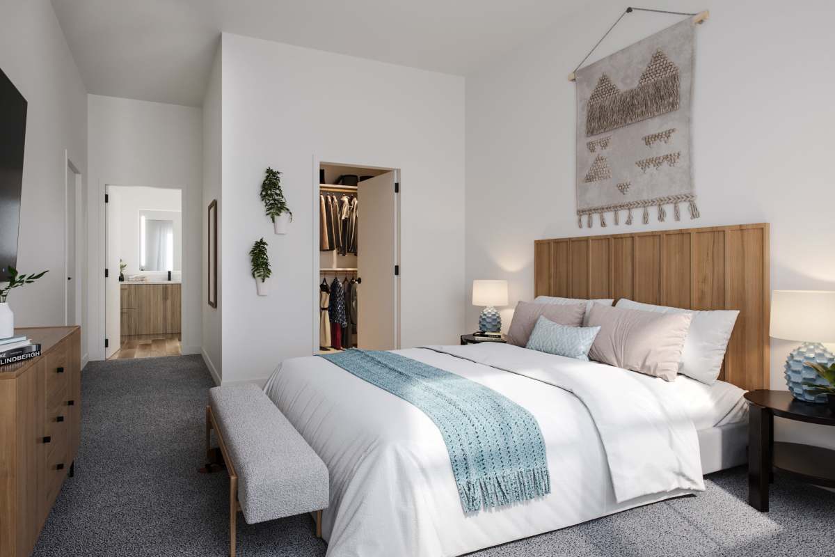 Bedroom with grey carpet and white material bed