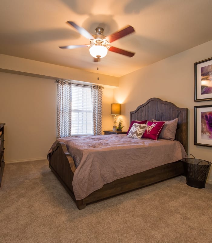 Chic bedroom with ceiling fan at Mission Point Apartments in Moore, Oklahoma