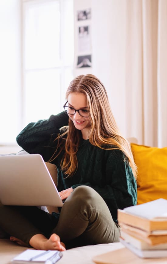 Student doing some class work in her apartment at University Courtyard in Denton, Texas