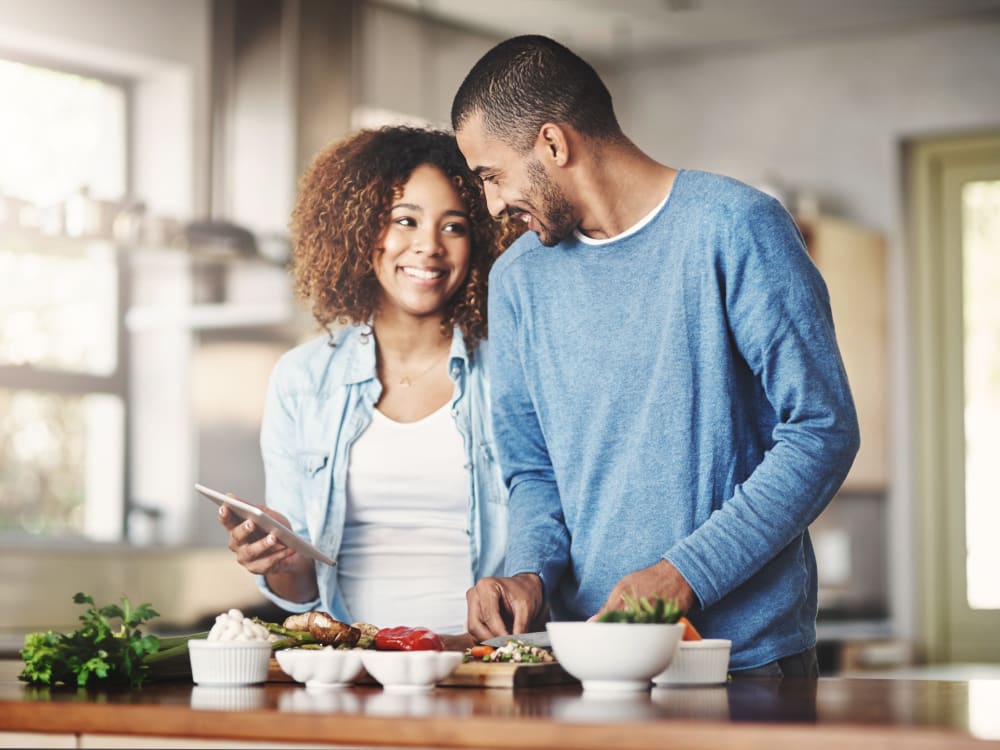 Residents cooking together at home at Terra Apartment Homes in Federal Way, Washington