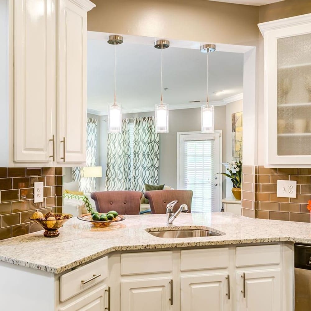 An apartment kitchen and dining room at The Courts of Avalon in Pikesville, Maryland