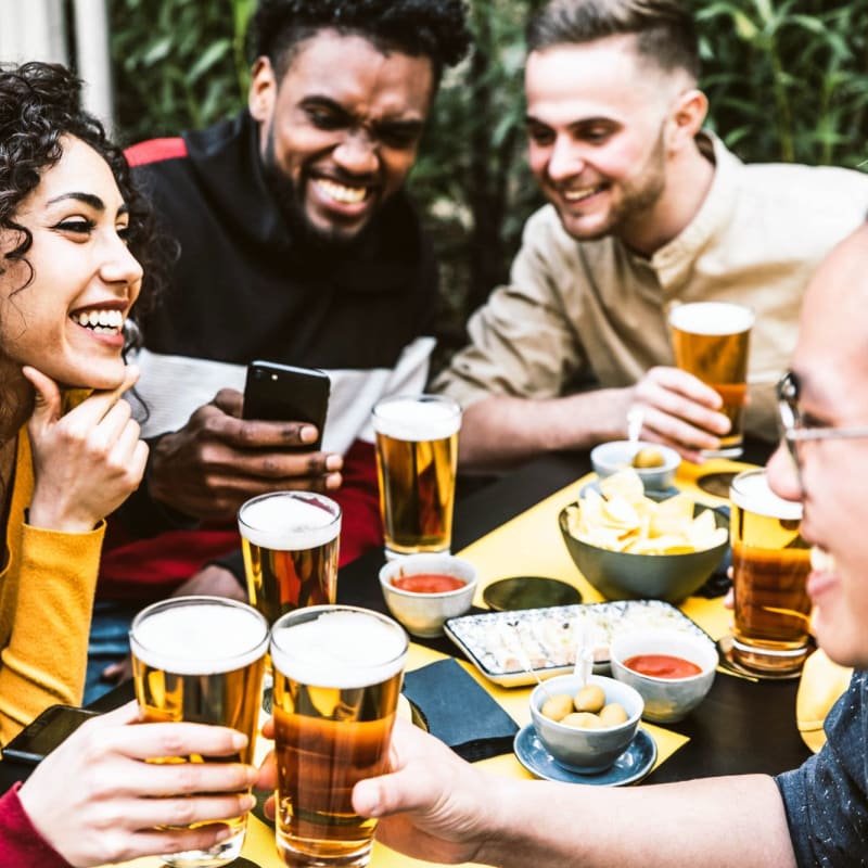 Friends enjoy a meal and beers at a local brewery near The Carlton at Greenbrier, Chesapeake, Virginia