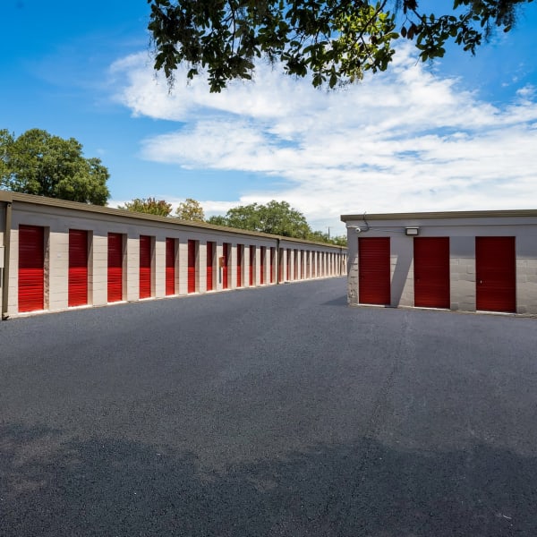 Outdoor storage units with red doors at StorQuest Self Storage in Clearwater, Florida