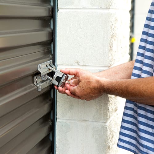 Customer locking storage unit at Red Dot Storage in DeKalb, Illinois