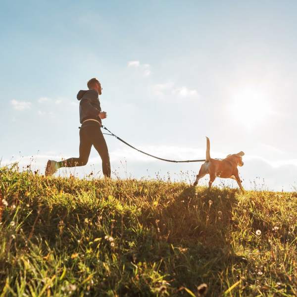 Resident and his dog jogging on a trail near The Abbey at Riverchase in Hoover, Alabama