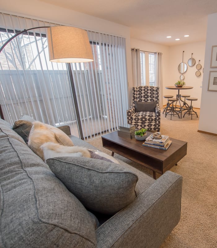 Carpeted living room at The Warrington Apartments in Oklahoma City, Oklahoma