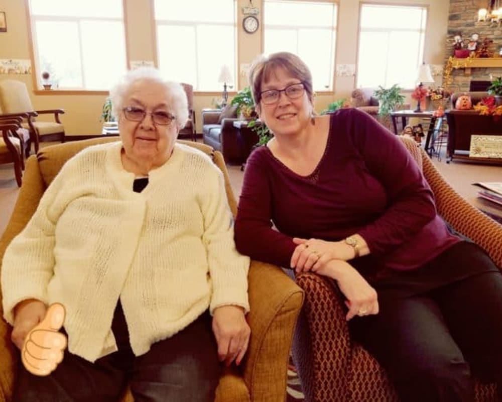 Resident and family visit in holiday decorated lounge at Manning Senior Living in Manning, Iowa.