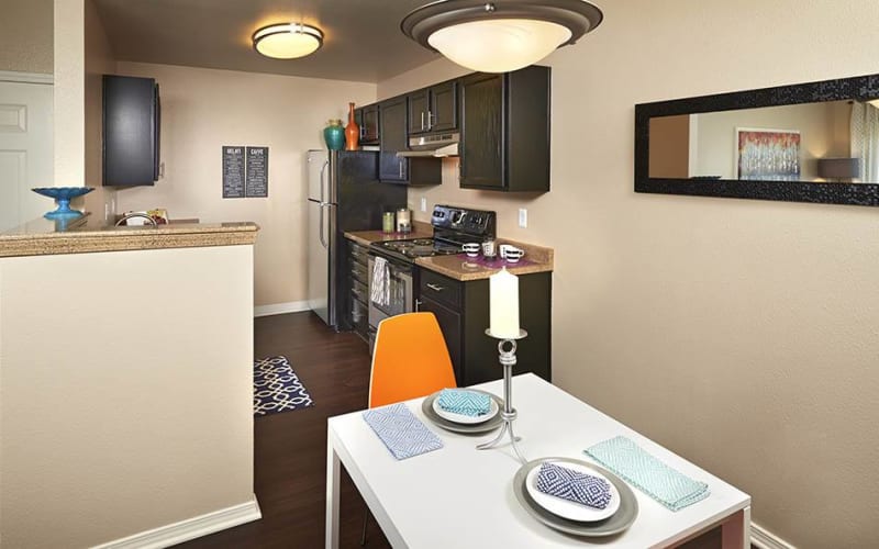 Renovated kitchen with espresso cabinets at Crossroads at City Center Apartments in Aurora, Colorado