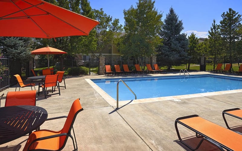 Covered seating near the swimming pool at Crossroads at City Center Apartments in Aurora, Colorado