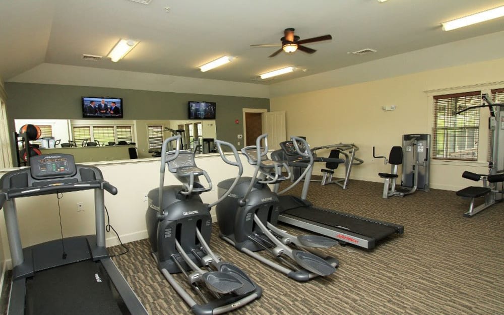 Well-equipped fitness center with cardio equipment at Preserve at Autumn Ridge in Watertown, New York