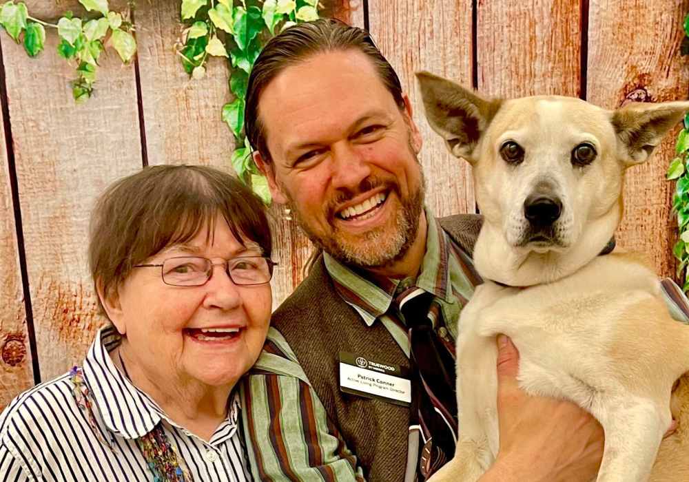 Resident and caretaker with a pup at Truewood by Merrill, First Hill in Seattle, Washington