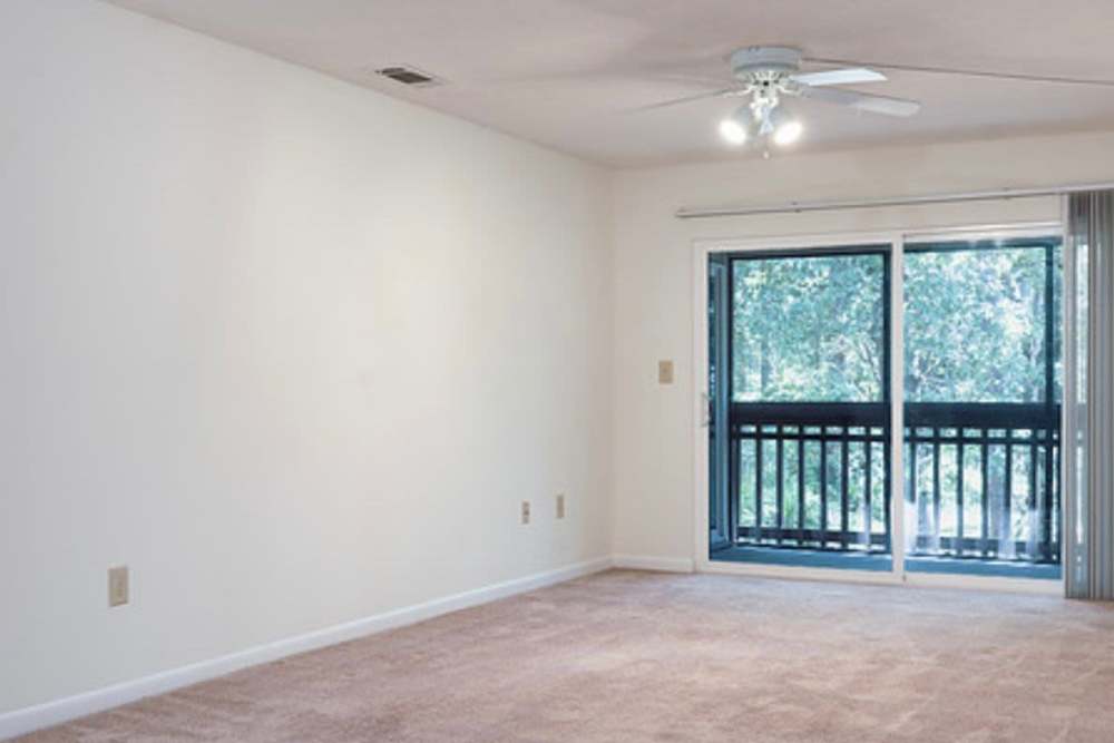 Living room with close access to patio at Creekwood Apartments in Gainesville,Florida