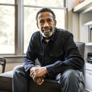 Resident sitting on a chair in his apartment at Hanover Place in Tinley Park, Illinois