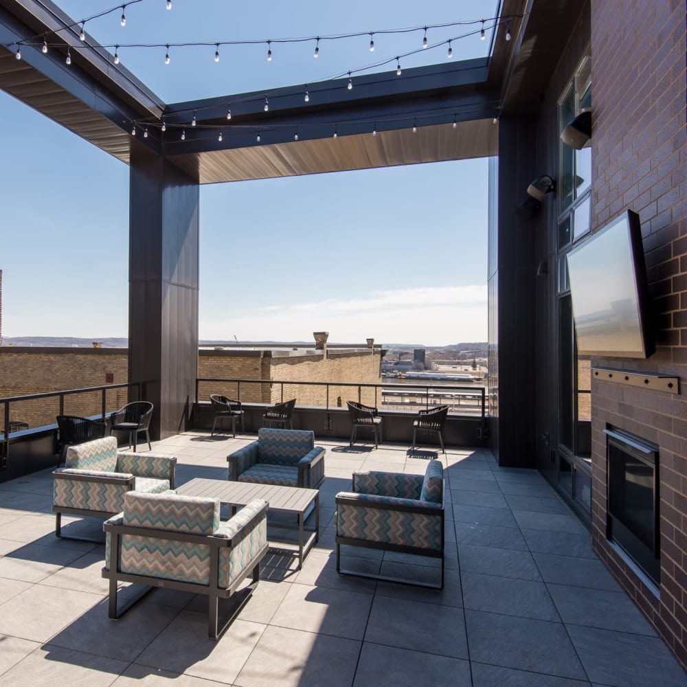 Outdoor lounge area with a fire pit on the rooftop at Oaks Union Depot in St Paul, Minnesota