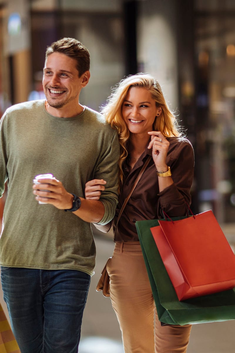 Resident couple holding shopping bags at West Hartford Collection in West Hartford, Connecticut