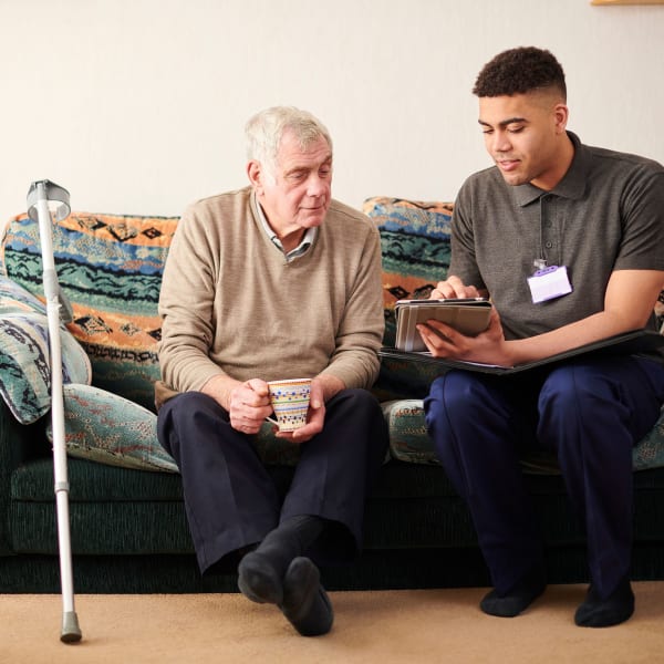 A staff member going over options with a resident at Tampa Gardens Senior Living in Tampa, Florida.