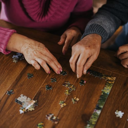 Residents putting a puzzle together at Oxford Vista Wichita in Wichita, Kansas