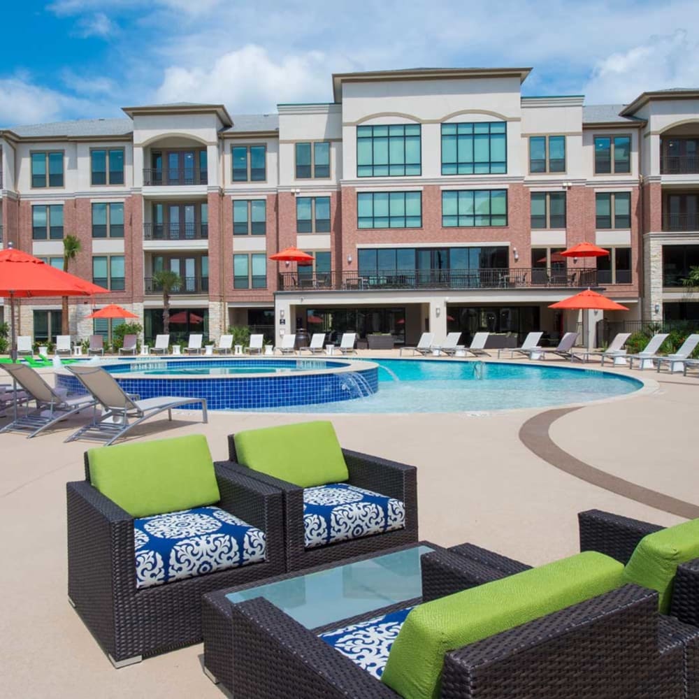 Resort-style swimming pool and outdoor lounge at Imperial Lofts in Sugar Land, Texas