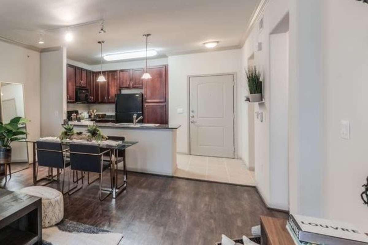 View of open kitchen and dining area from living room at Villas At Bunker Hill, Houston, Texas