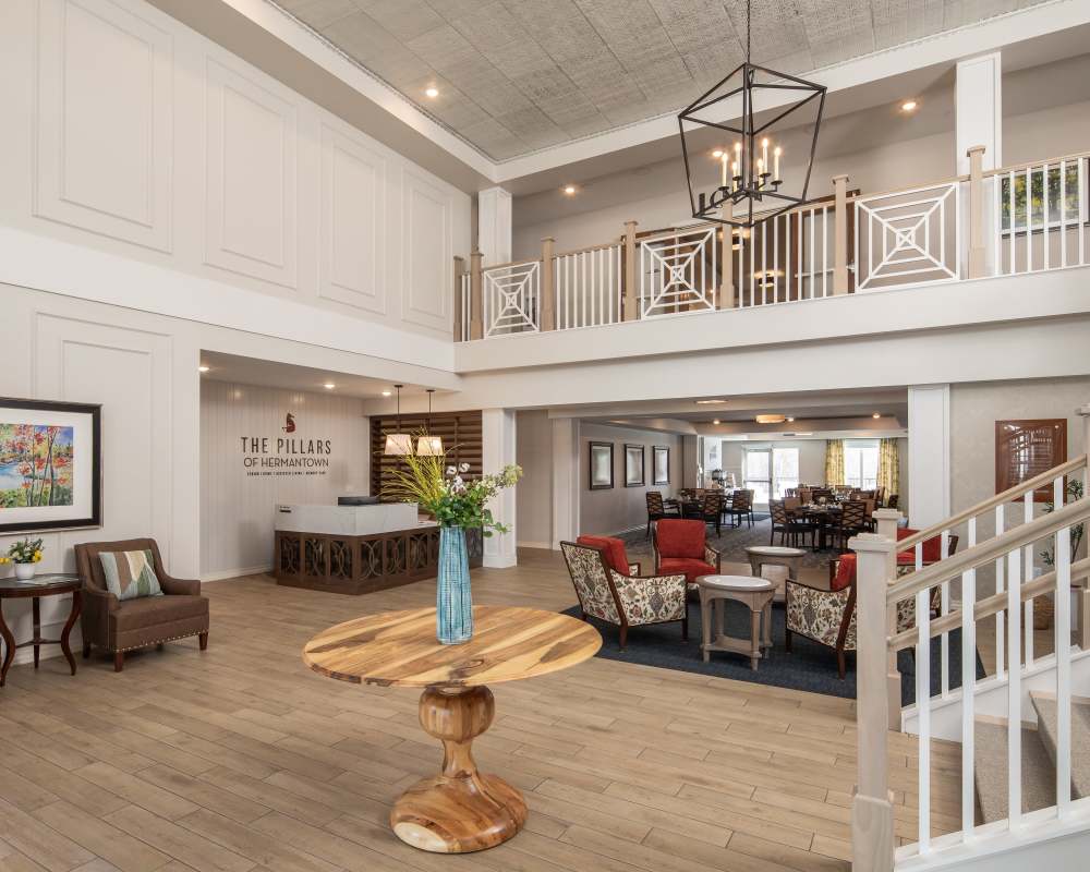 Building interior with hardwood floors, wooden cabinets, and stainless steel appliances at The Pillars of Hermantown in Hermantown, Minnesota