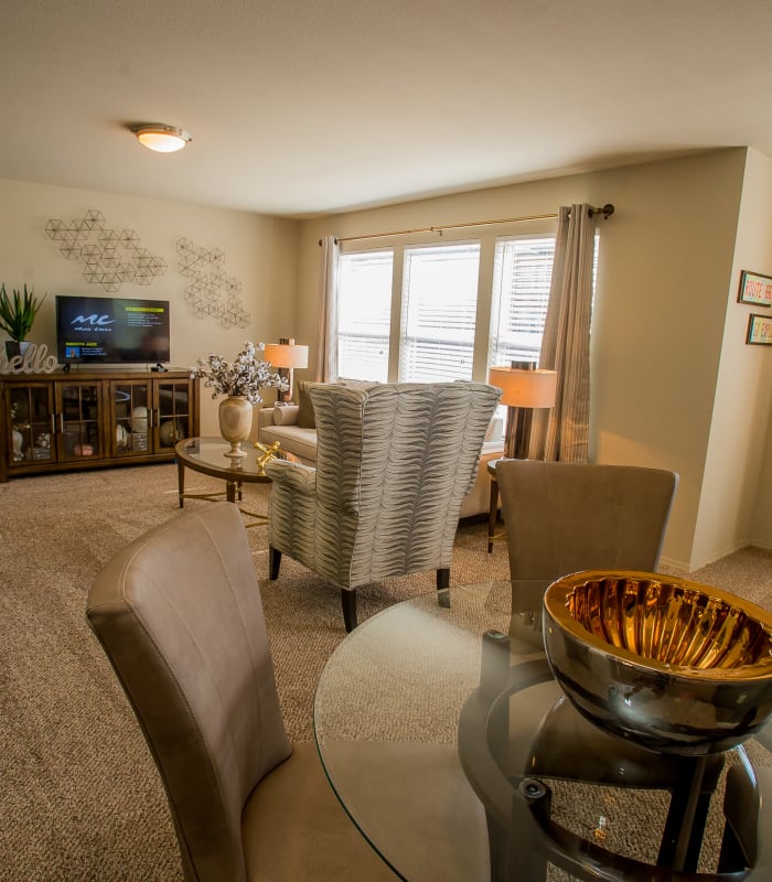 Spacious living room with large windows at Icon at Broken Arrow in Broken Arrow, Oklahoma