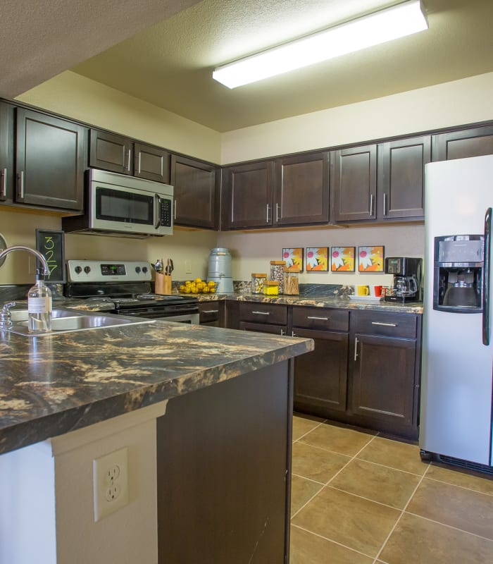 Kitchen with granite countertops at Mission Point Apartments in Moore, Oklahoma