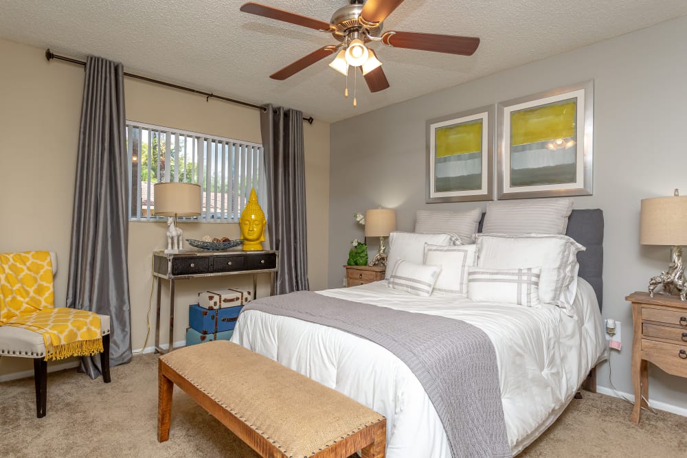 A primary bedroom with ceiling fan at Fairway View Apartments in Hialeah, Florida