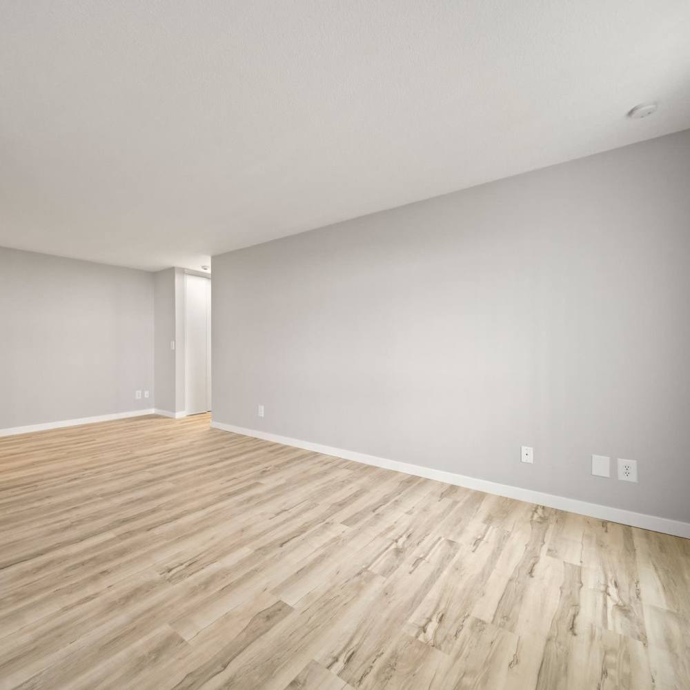 Living room with wood-style flooring at Morada in Crystal, Minnesota