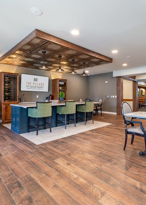 Community dining and bar area with seating at The Pillars of Grand Rapids in Grand Rapids, Minnesota