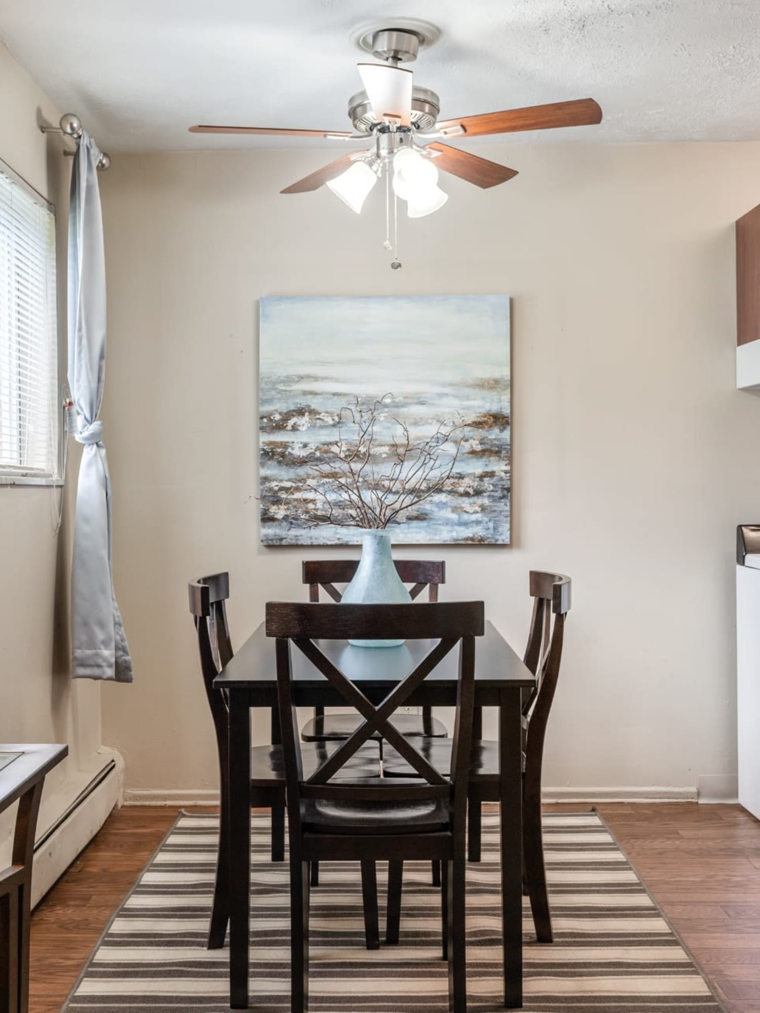 A spacious dining room with a ceiling fan at Centennial Woods Apartments in Cincinnati, Ohio