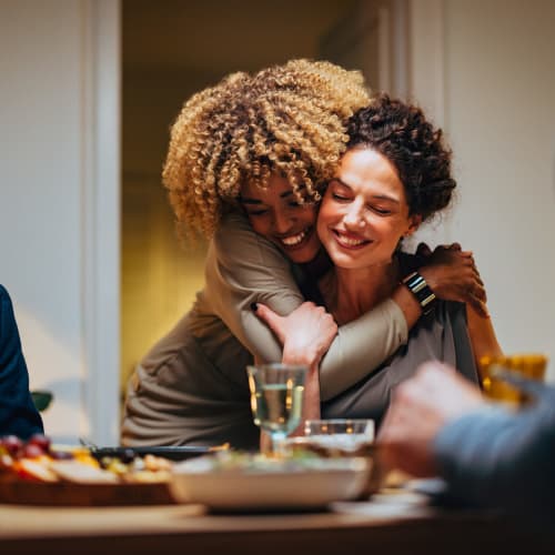 Friends hugging at dinner at Sherwood in Folsom, California